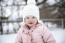 a toddler girl outdoors in snow 