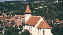 aerial view over a tile roof church 