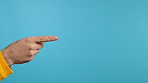 Hands of man, he indicates with finger on right side copy space. Guy pointing, presenting and showing something isolated on blue background. High quality 4k footage