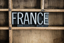 word France in blocks on a bookshelf 
