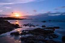 a rocky beach at dawn 