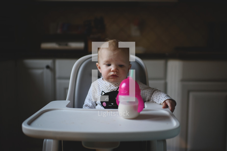 a baby sitting in a high chair 
