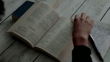 a teen reading a Bible and taking notes 