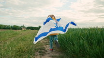 Happy israeli jewish little boy runs with Israel national flag. Independence Day. Patriotism. Symbol of democracy, independence, future. High quality 4k footage