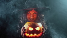 Mysterious Black Witch With Steaming Pumpkin As Head Of Jack-O-Lantern On Dark