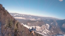 Proximity paragliding fly above forest nature in sunny winter mountains, Freedom Adrenaline adventure
