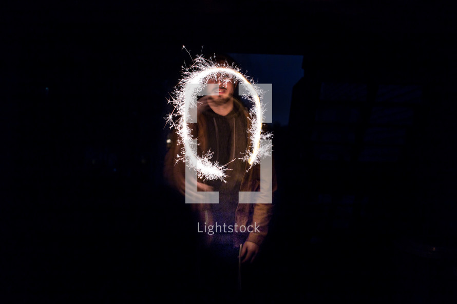 a man swirling light 