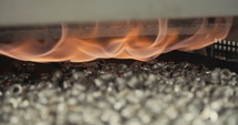 Metal parts during heat and coating process in a production facility