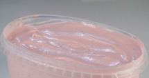 Close up slow motion of scooping of strawberry ice cream