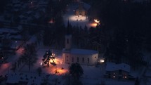 Aerial view of church during a snowy winter night