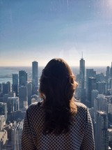 woman looking out over a city 