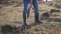 The Farmer Is Digging The Ground With A Shovel For Tree Planting. Slow Motion Shot	