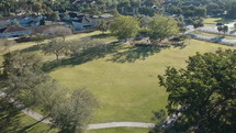 aerial view over a park and neighborhood 
