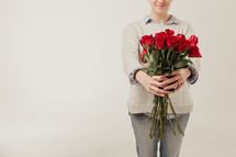 woman holding long stem roses