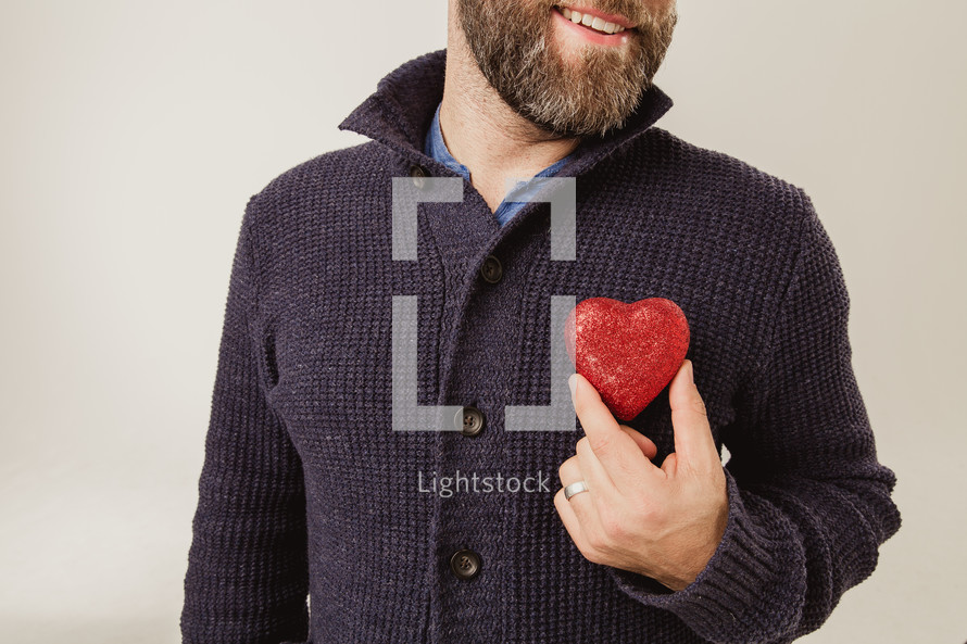 man holding a heart over his heart 