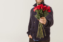 man holding long stem roses 
