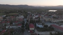 Aerial of small town in Eastern Europe with mountains in the background