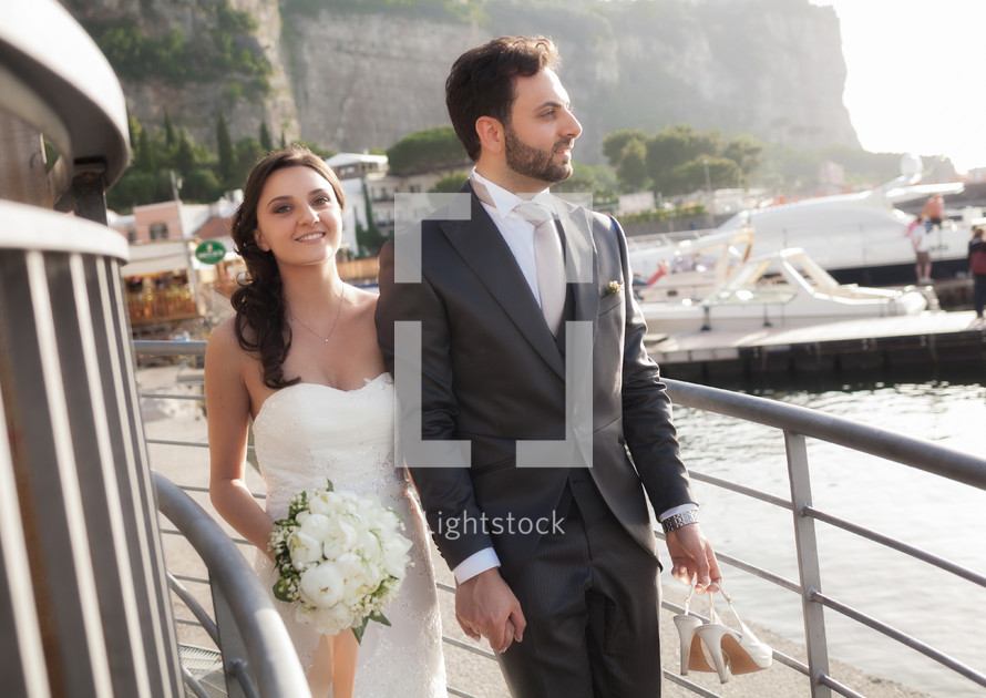 bride and groom at a harbor 