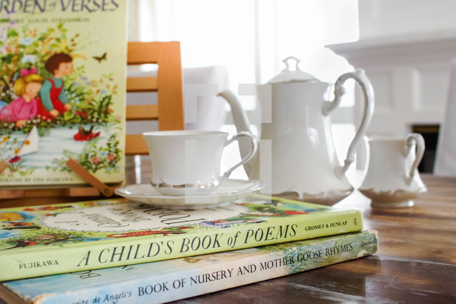 a child's book of poems and nursery rhymes book and tea 