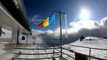 Romanian Flag on top of the mountain as seen from Sinaia, Romania
