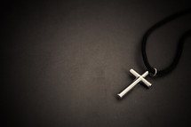 cross necklace on a black background 