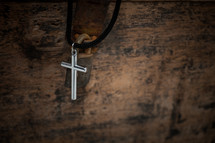 cross necklace on a wooden box 
