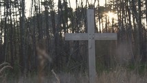wooden cross in front of a forest 