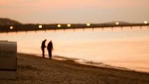 a couple on a beach at sunset 