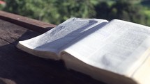 open Bible on a railing outdoors 