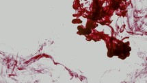 spreading red ink in water