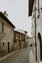 a narrow street between buildings 
