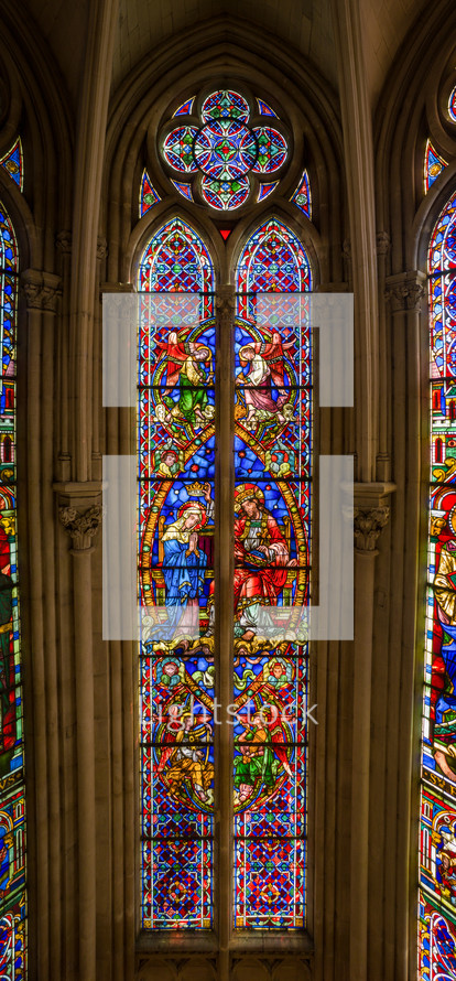  Stained glass windows Montpellier  church colorful designs and the way they cast colored light into the interior when sunlight shines through them. depict biblical scenes, saints, angels, and other religious symbols.