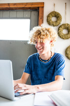 teen boy on a computer for virtual learning 