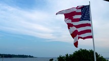 waving American flag on a shore 