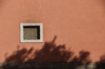 small window on the side of a house in Italy 