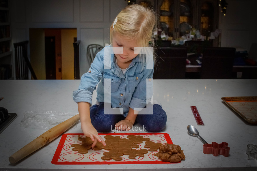 a girl baking Christmas cookies 