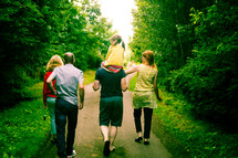 family walking outdoors on a path 