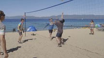 people playing volleyball on the beach 