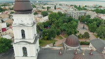 Old european city aerial sightseeing. Flying above centre district. Drone view. Sea on horizon. Close up ancient christian cathedral building.