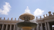 Old fountain and beautiful building with columns. Slow motion. Architecture and landmark of Vatican. Water drops splashing and dripping on fountain surface in european city.