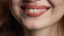 Close-up mouth of charming woman. Perfect healthy lips, teeth. Emotional fun and joy lifestyle. High quality 4k footage 