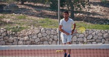 Slow motion of a tennis player serving the ball during a tennis game