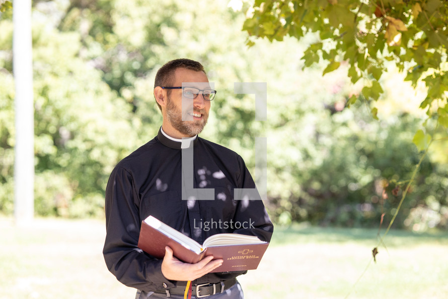 Priest preaching outside