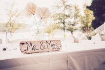 Mr and Mrs sign and white tablecloth on a table 