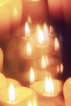 Candle seen through faceted crystal