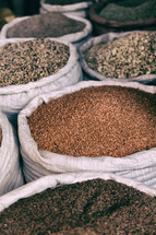 sacks of grains and spices at a market 