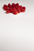 A bunch of raspberries isolated on white