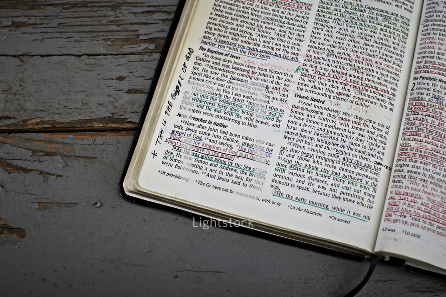 An open Bible with notes and underlining