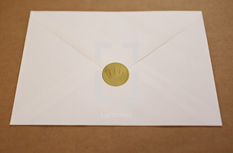 A sealed Christmas card in envelope with golden crown of the King as seal.