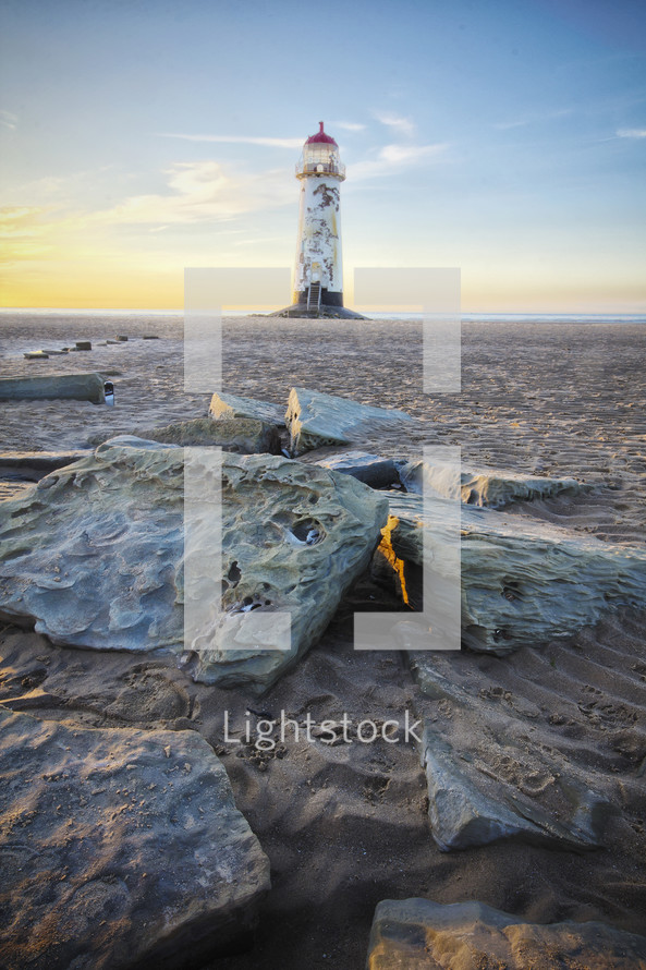 a lighthouse on a beach 